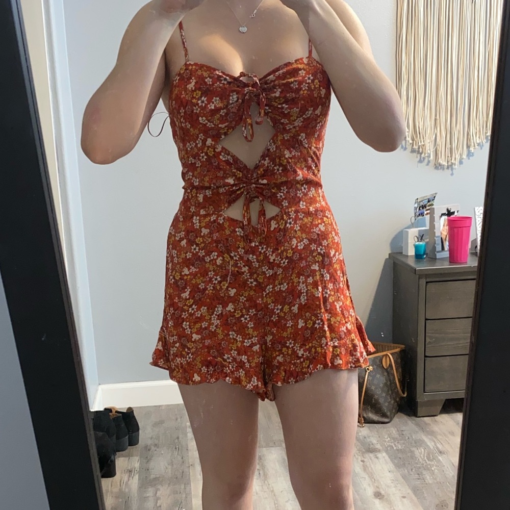 Cut out romper. Size medium. Still has the tags.
